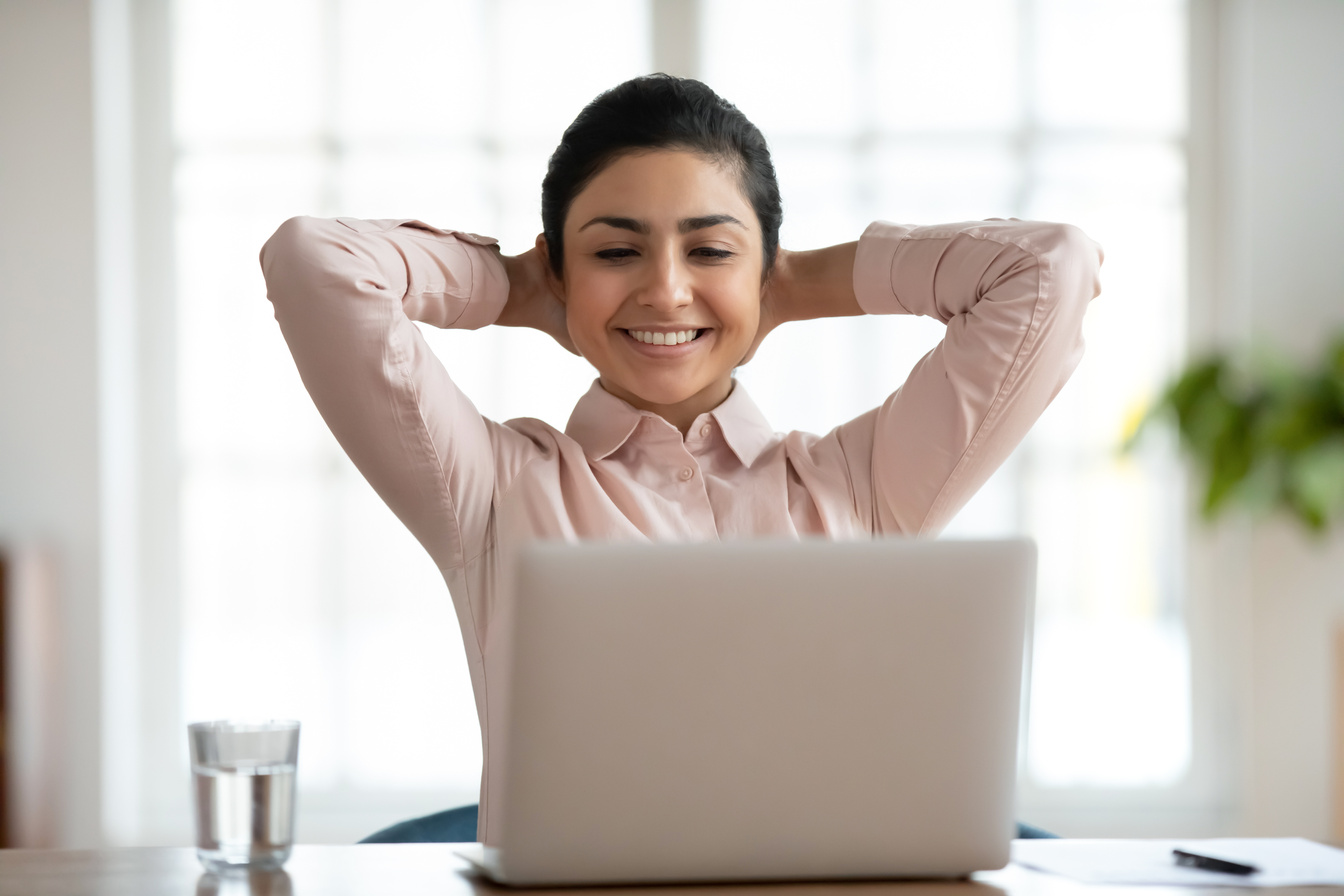 Happy indian female employee relax at workplace